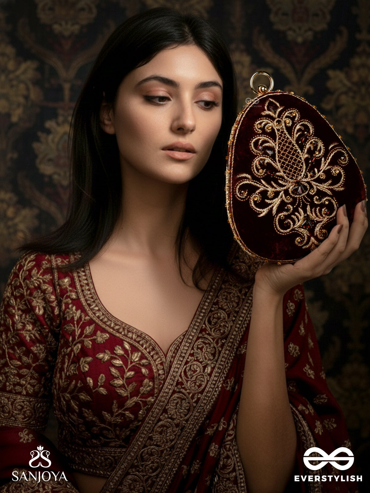 Noor – Oval Maroon Velvet Clutch With Rich Zardozi Embroidery And Golden Metal Frame