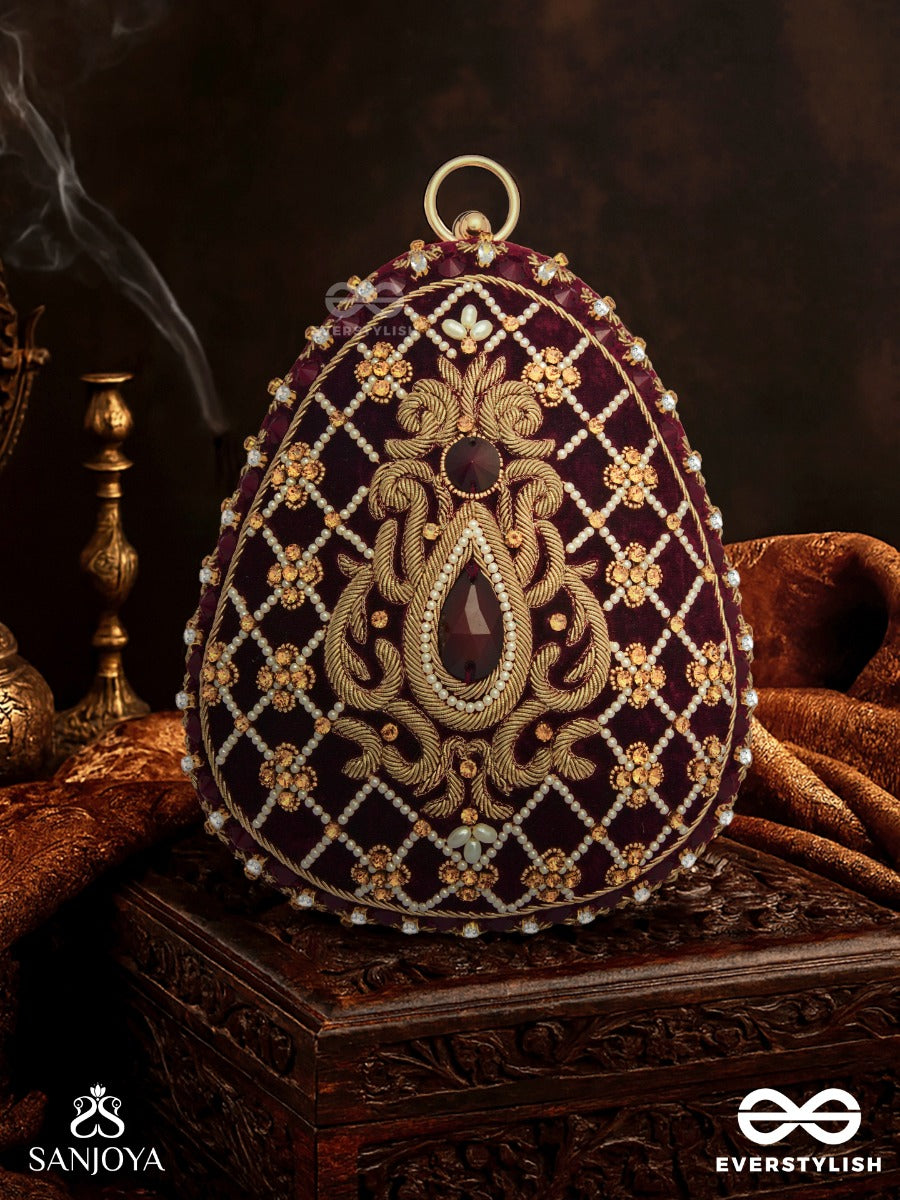 Shahnaz – Oval Maroon Velvet Clutch With Intricate Zardozi Embroidery And Golden Metal Frame