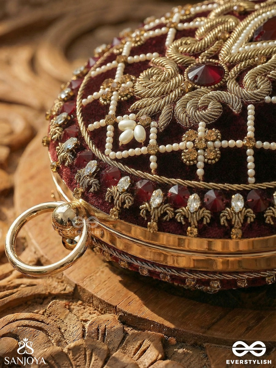 Shahnaz – Oval Maroon Velvet Clutch With Intricate Zardozi Embroidery And Golden Metal Frame