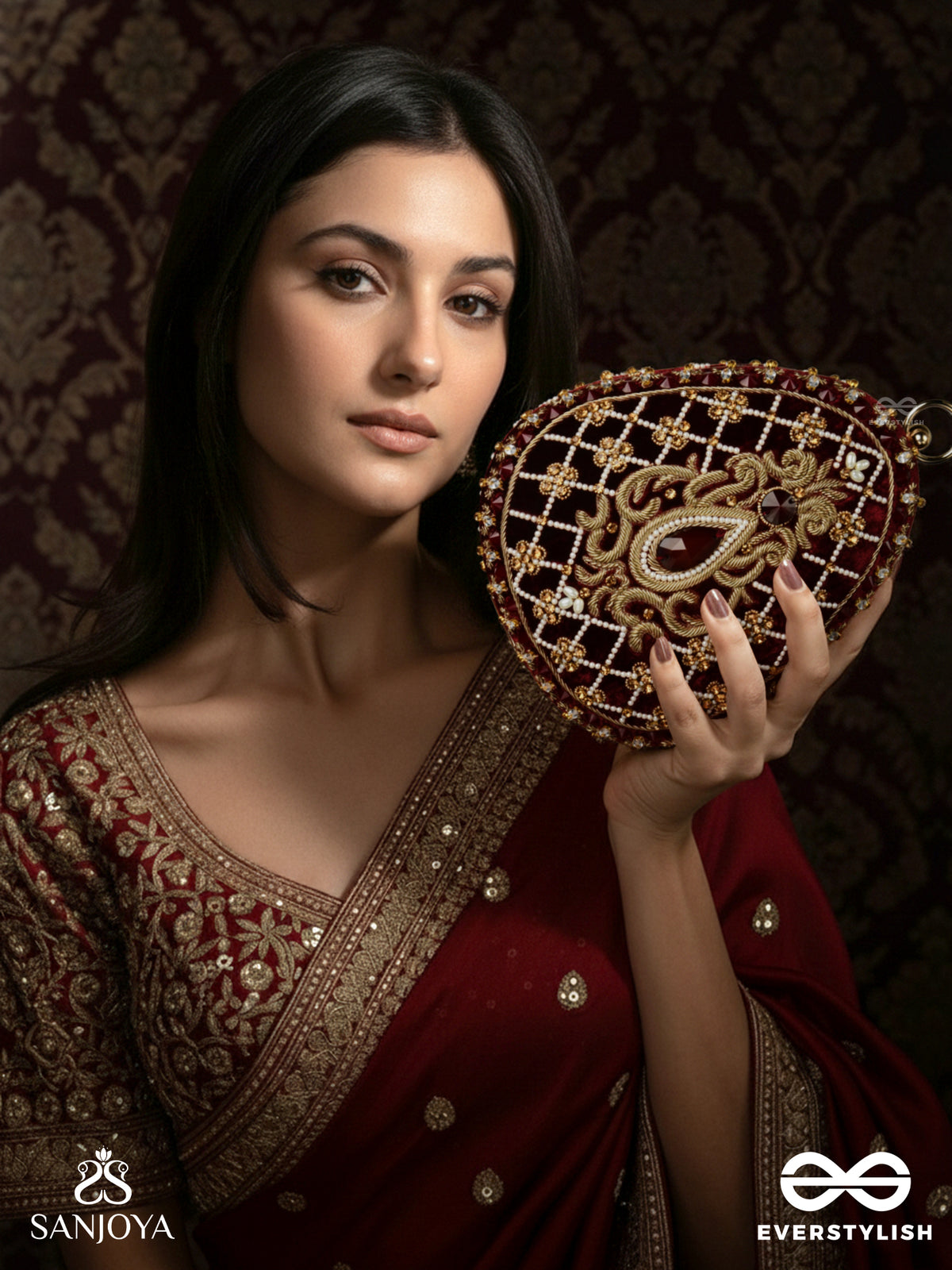 Shahnaz – Oval Maroon Velvet Clutch With Intricate Zardozi Embroidery And Golden Metal Frame