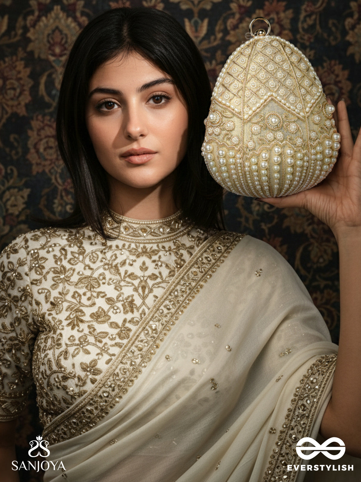Sahiba  – Oval Ivory Silk Clutch With Pearl Embedding And Golden Metal Frame