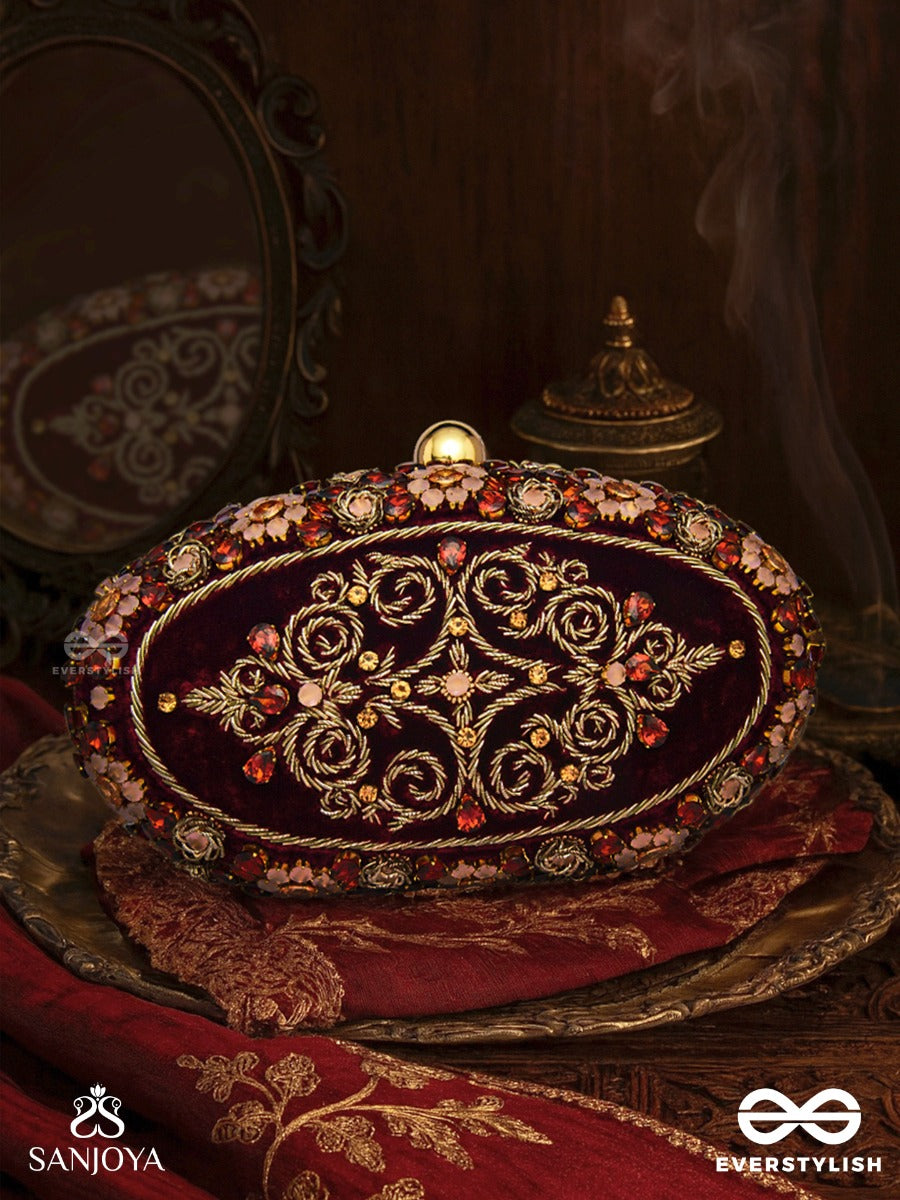 Zevariya – Heirloom-Style Oval Clutch With Intricate Zari Detailing And Golden Metal Frame