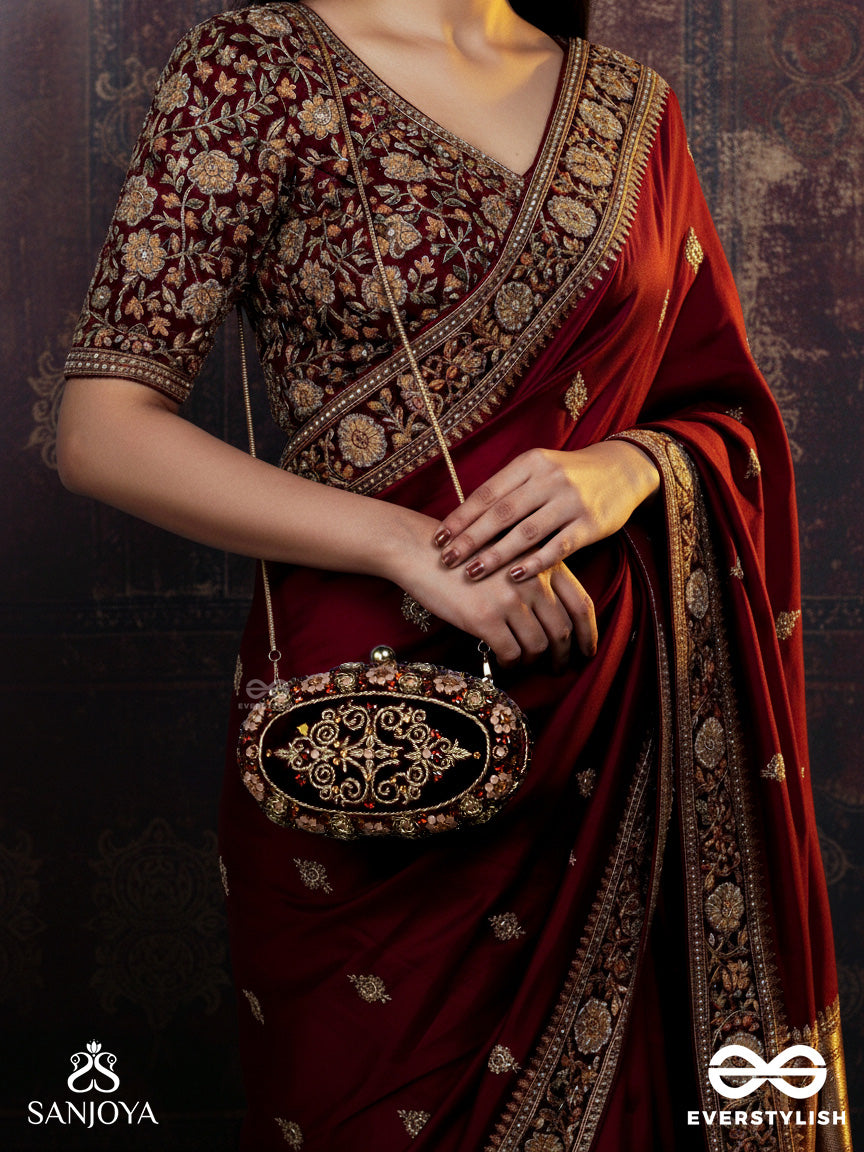 Zevariya – Heirloom-Style Oval Clutch With Intricate Zari Detailing And Golden Metal Frame