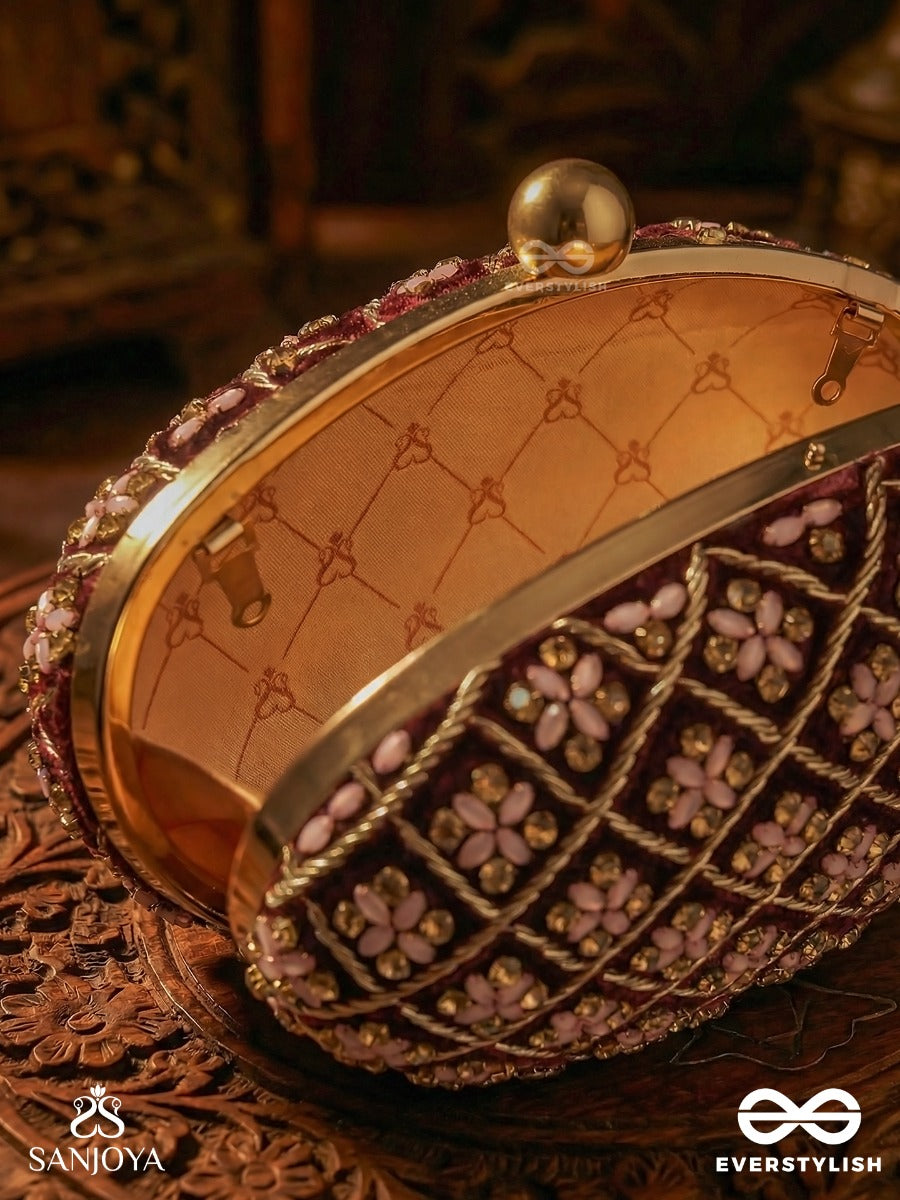 Nazrana – Curved Maroon Shade Textile Clutch With Ornamented Grid Embellishment And Golden Metal Frame