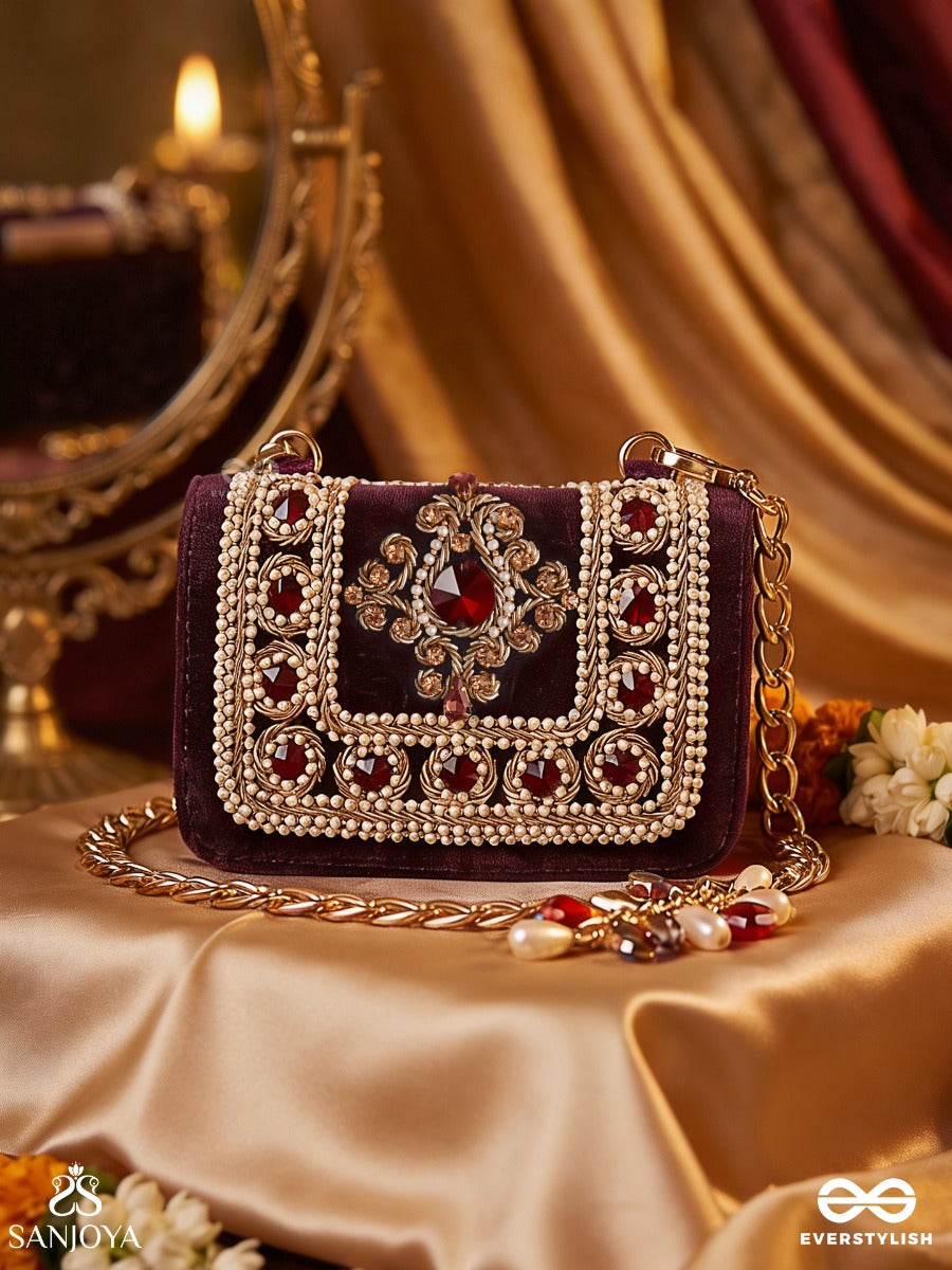 Vilasini – Rectangular Wine Velvet Clutch With Ornate Gem Embellishment, Pearl Framework And Charm Detail