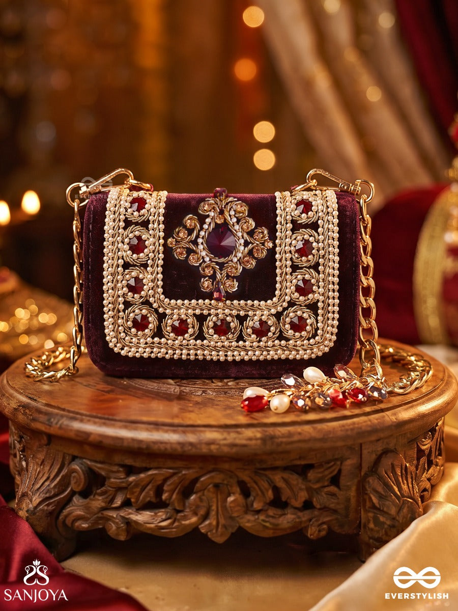 Vilasini – Rectangular Wine Velvet Clutch With Ornate Gem Embellishment, Pearl Framework And Charm Detail