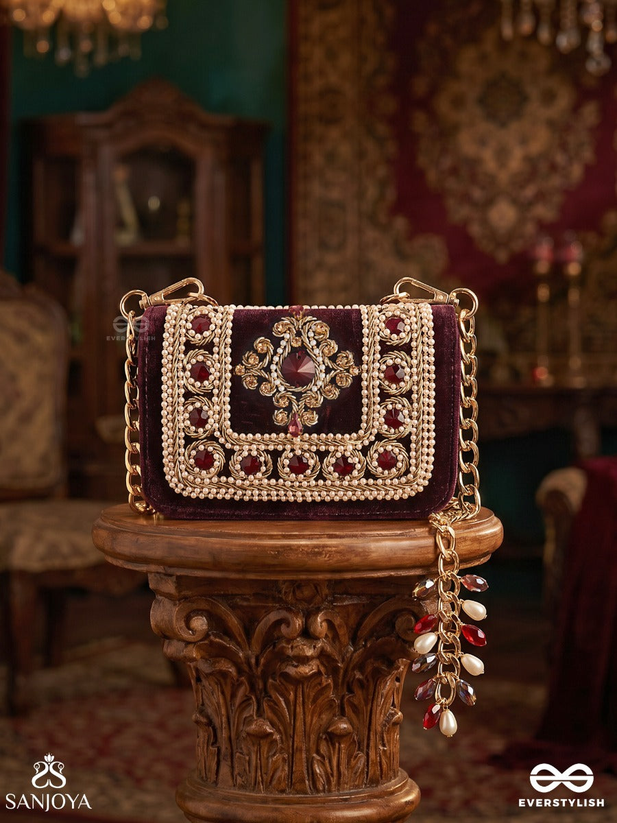 Vilasini – Rectangular Wine Velvet Clutch With Ornate Gem Embellishment, Pearl Framework And Charm Detail