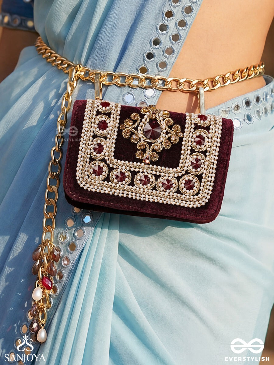 Vilasini – Rectangular Wine Velvet Clutch With Ornate Gem Embellishment, Pearl Framework And Charm Detail