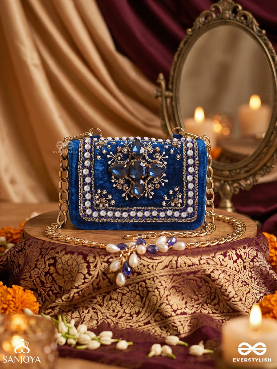 Kadambari – Rectangular Royal Blue Velvet Clutch With Ornate Gem Embellishment, Pearl Framework And Tassel Detail