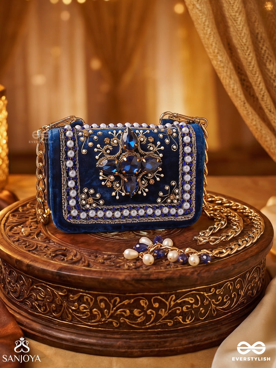 Kadambari – Rectangular Royal Blue Velvet Clutch With Ornate Gem Embellishment, Pearl Framework And Tassel Detail