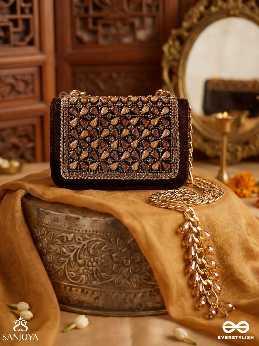 Mriganayani – Rectangular Maroon Velvet Clutch With Ornate Amber Stone Embellishment, Gold Framework And Tassel Charm