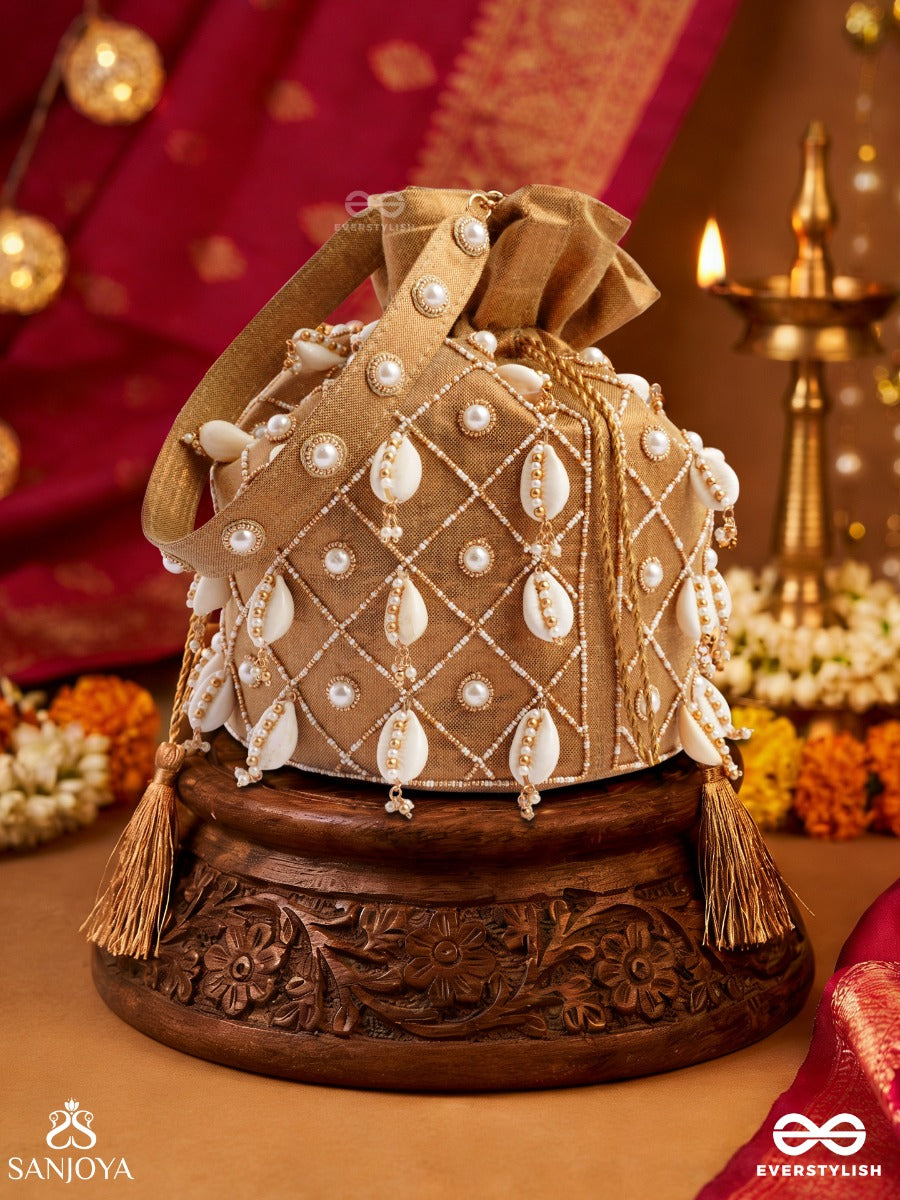Saharish – Potli Champagne Beige Bag With Shell Embellishment, Pearl Detailing And Tassel Tie Accents