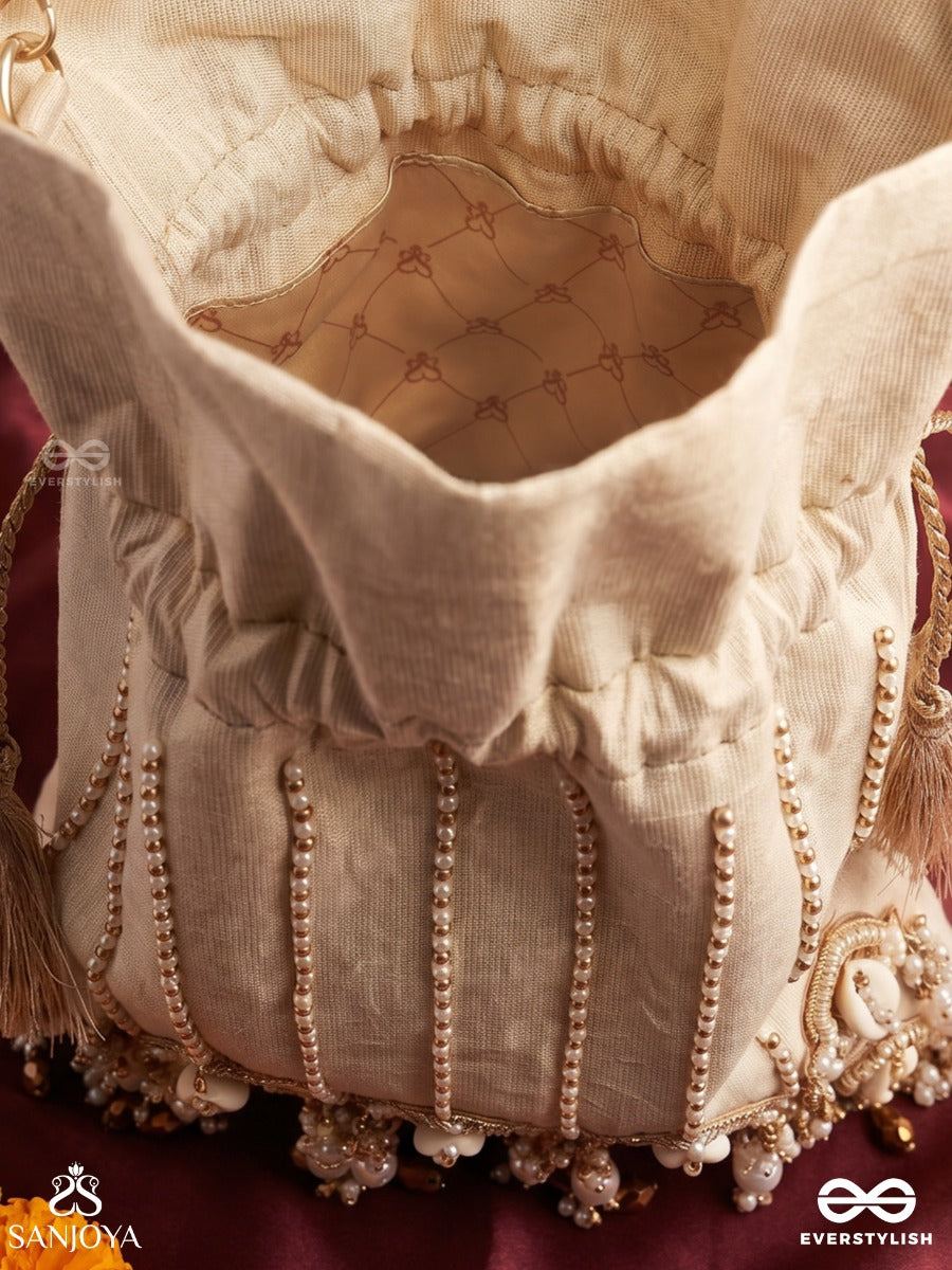 Yasmeenah – Potli Light Champagne Bag With Handplaced Pearl Hangings, Ornamental Thread Accents And Braided Ties