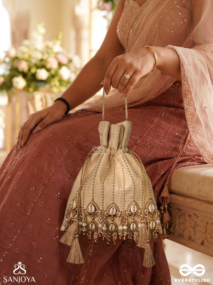 Yasmeenah – Potli Light Champagne Bag With Handplaced Pearl Hangings, Ornamental Thread Accents And Braided Ties
