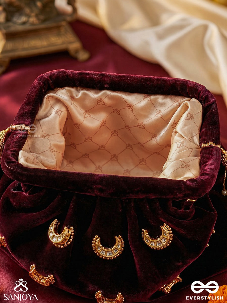 Ayshaan – Oval Burgundy Velvet Clutch With Kundan Moon Motifs, Delicate Pearlwork And Draped Silhouette