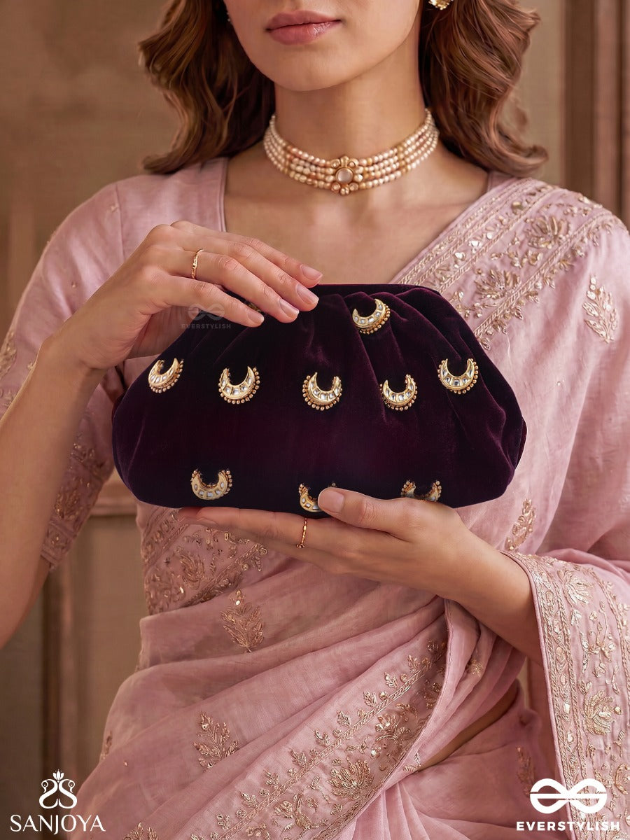 Ayshaan – Oval Burgundy Velvet Clutch With Kundan Moon Motifs, Delicate Pearlwork And Draped Silhouette