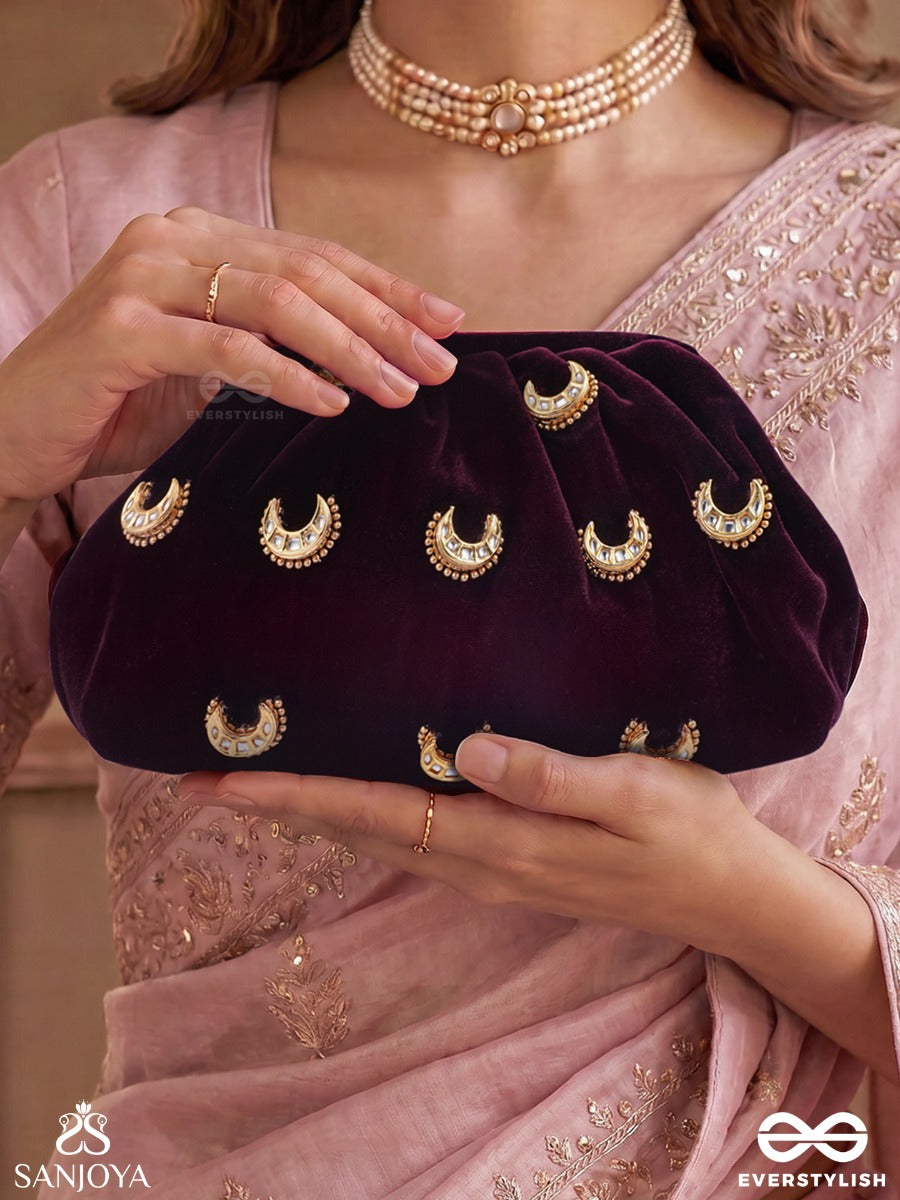 Ayshaan – Oval Burgundy Velvet Clutch With Kundan Moon Motifs, Delicate Pearlwork And Draped Silhouette